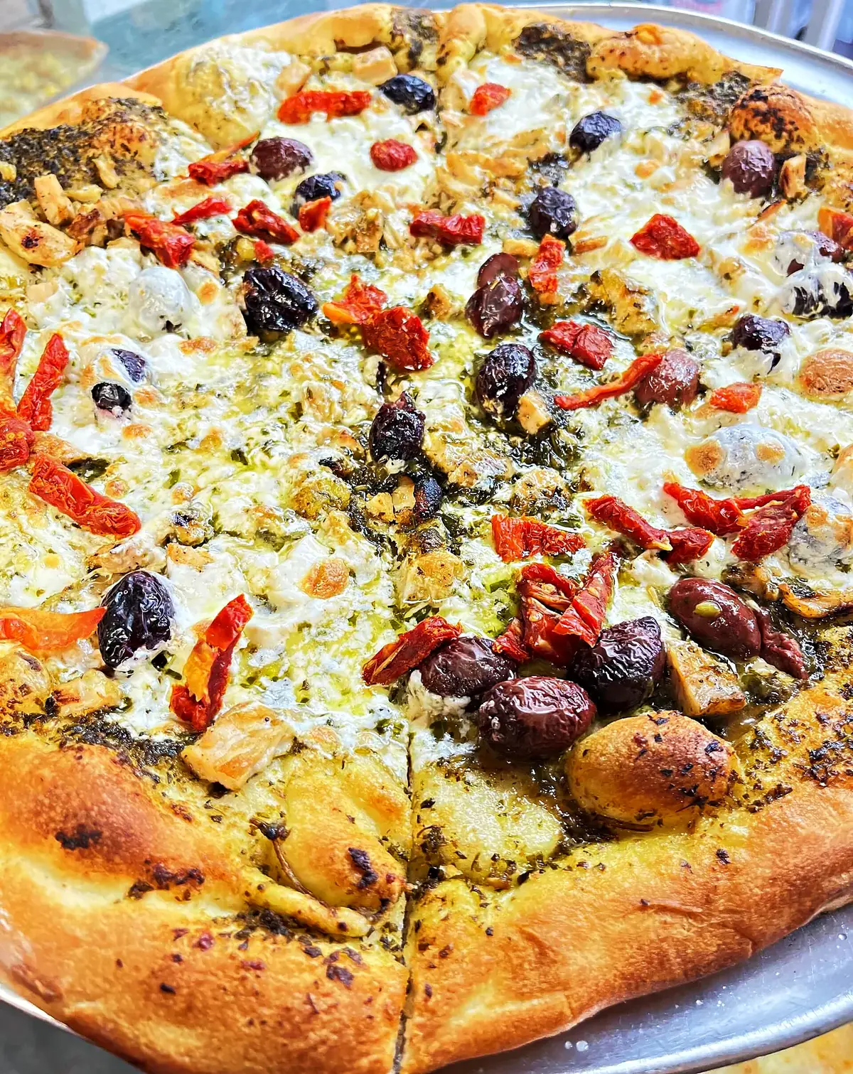 Brick-oven pie with olives, peppers and sausage