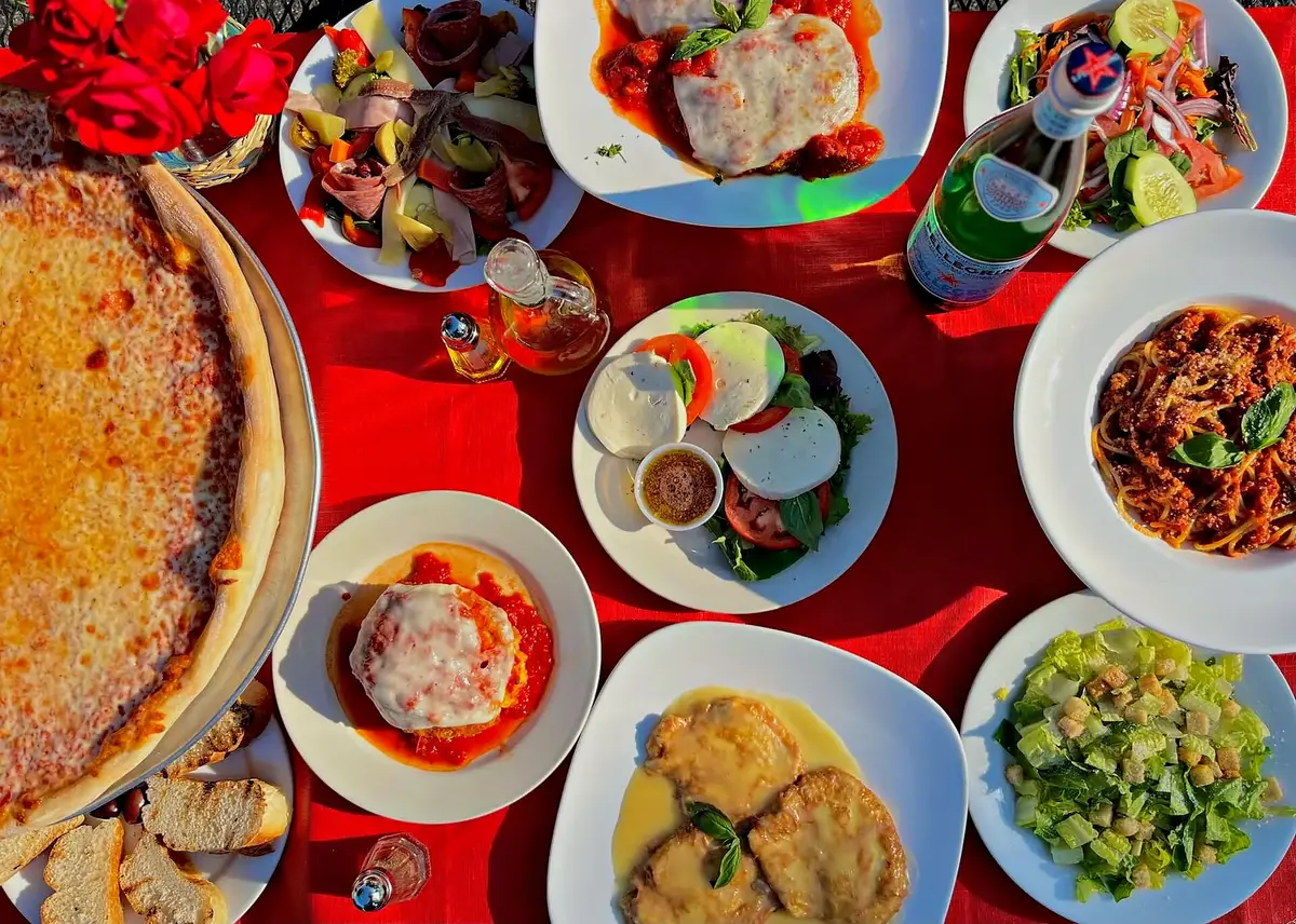 A table of plates on a red tablecloth