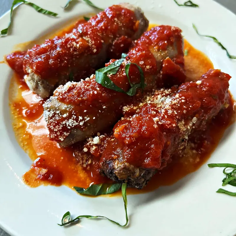 Braciole and sausage in tomato sauce