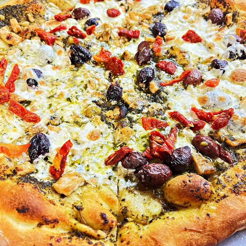 Brick-oven pie with olives, peppers and sausage